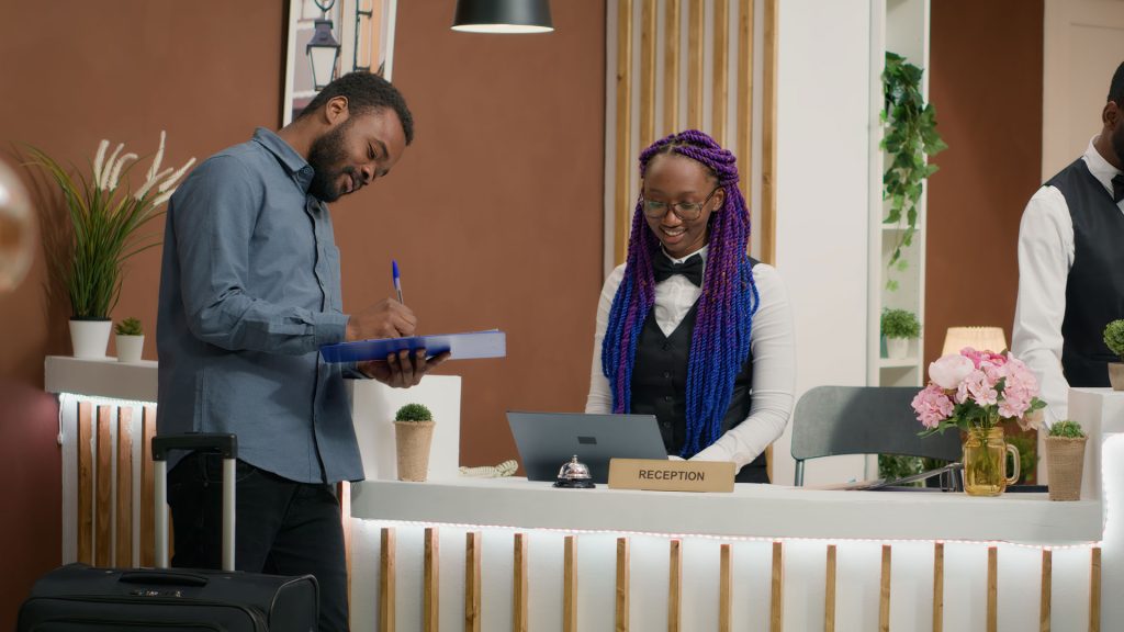 Man signing into an Hotel